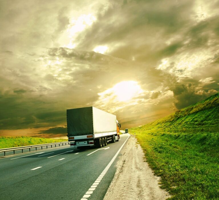 total truck support services truck - A large white truck drives down a highway on a sunny day with dramatic clouds overhead.